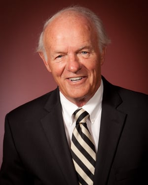 Denny Corp Headshot maroon background